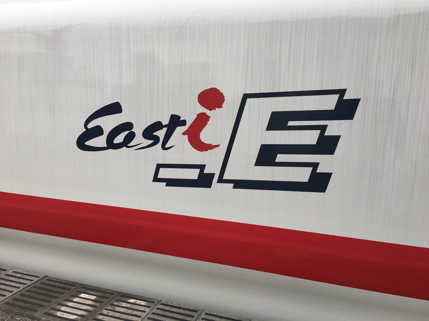 The East iE logo painted on the side of the train.